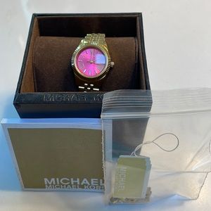 Michael Kora watch, gold with pink face.